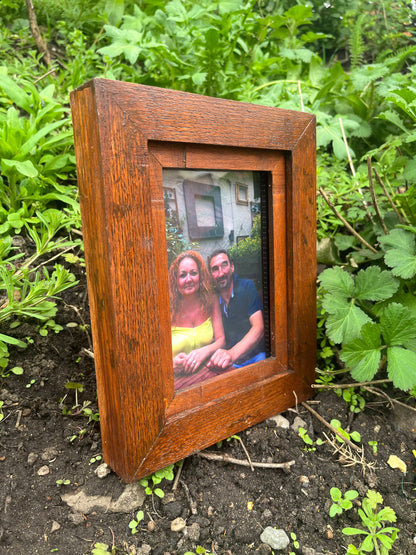 oak wood heartwood memorial photo frame with a picture of two people on a grassy ground